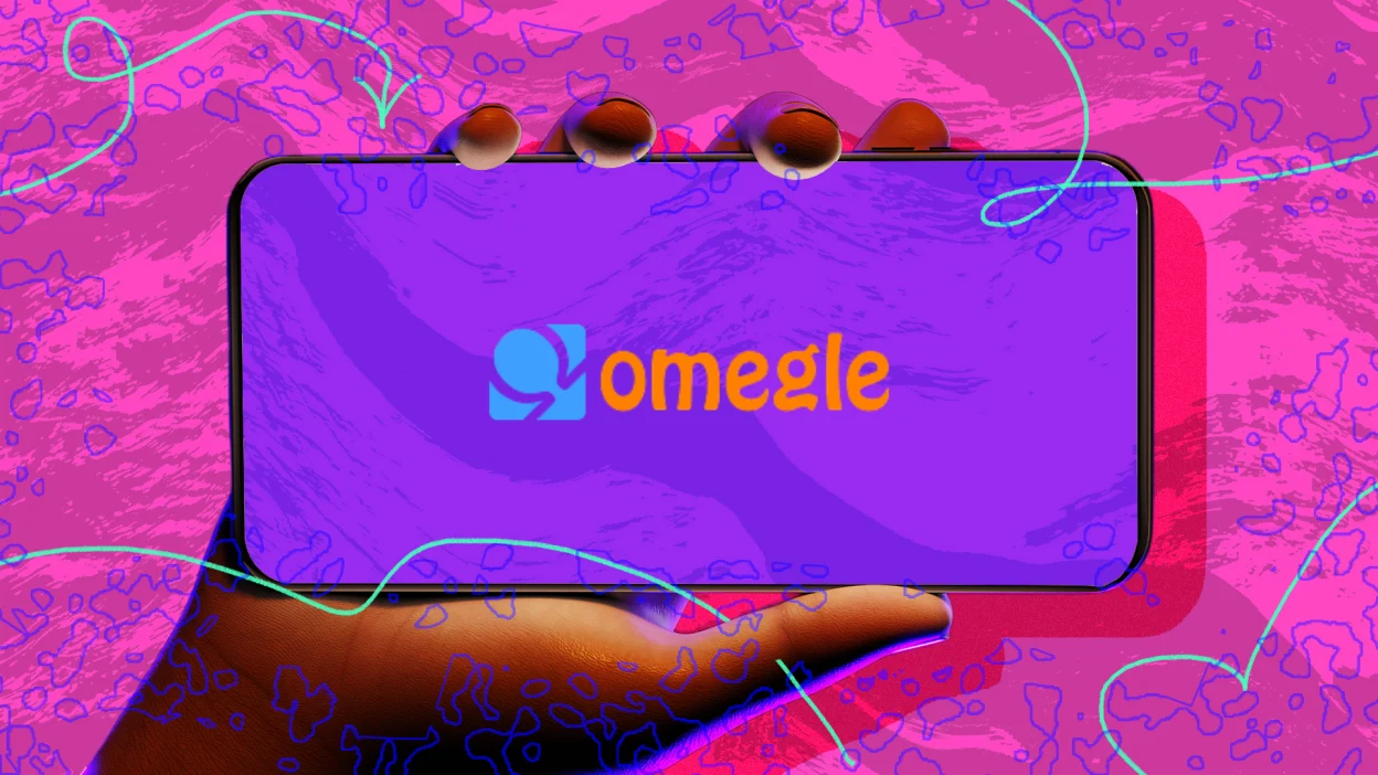 A phone holds a phone in front of a pink background. The 'Omegle' logo appears on screen.