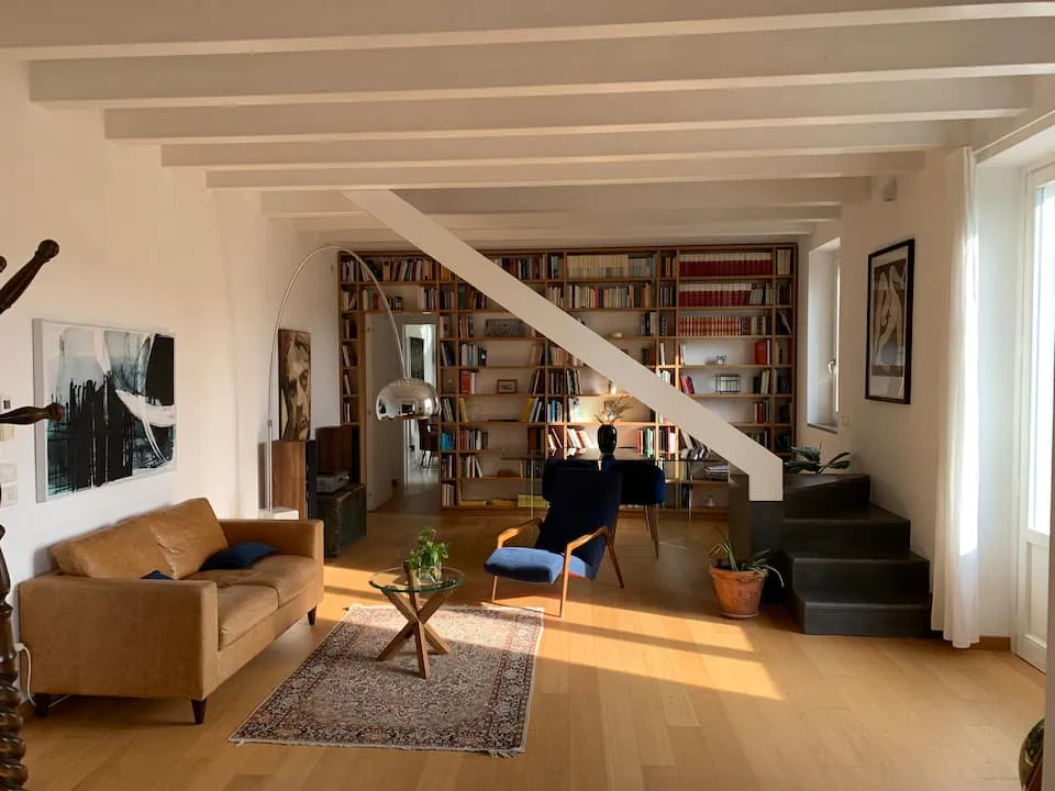 Image may contain Home Decor Rug Architecture Building Furniture Indoors Living Room Room Couch Art and Painting