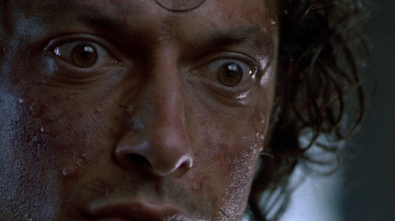 Jeff Goldblum as Seth Brundle looking scared in The Fly
