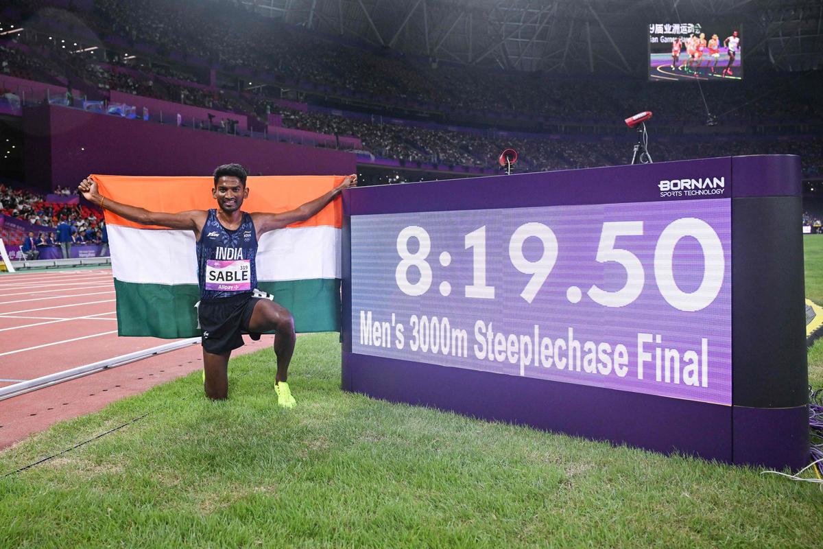 Avinash Sable celebrates after winning the 3,000m steeplechase final at the 2022 Asian Games in Hangzhou.