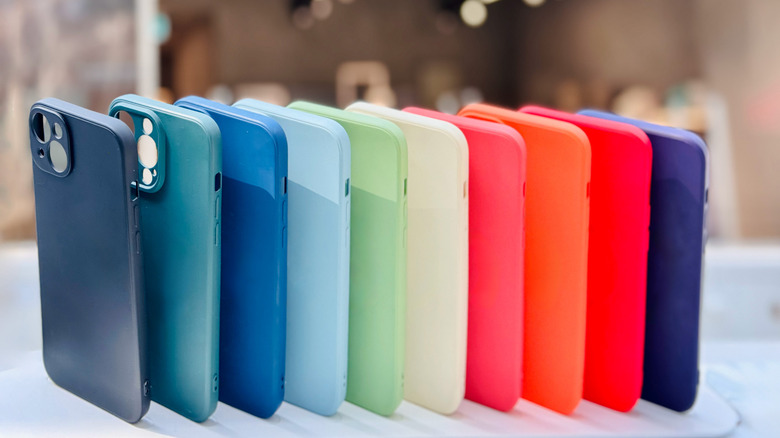 Selection of simple phone cases in a range of colors, stacked upright next to each other