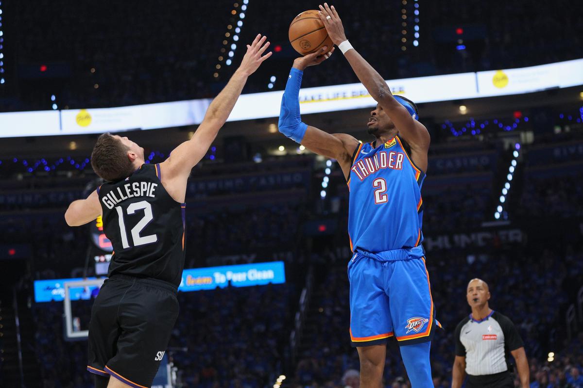 Oklahoma City Thunder guard Shai Gilgeous-Alexander (2) looks to shoot over Phoenix Suns guard Collin Gillespie (12). Oklahoma City Thunder guard Shai Gilgeous-Alexander (2) looks to shoot over Phoenix Suns guard Collin Gillespie (12).