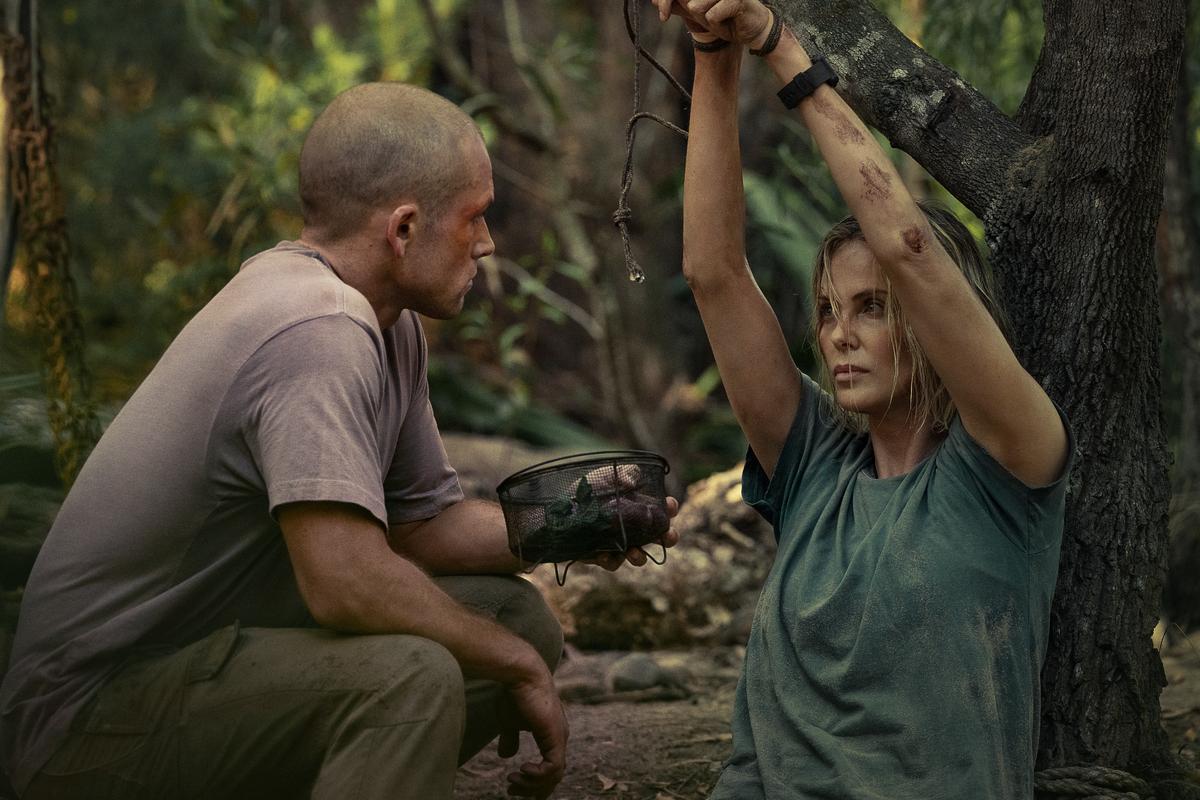Taron Egerton as Ben and Charlize Theron as Sasha in ‘Apex’ Taron Egerton as Ben and Charlize Theron as Sasha in ‘Apex’