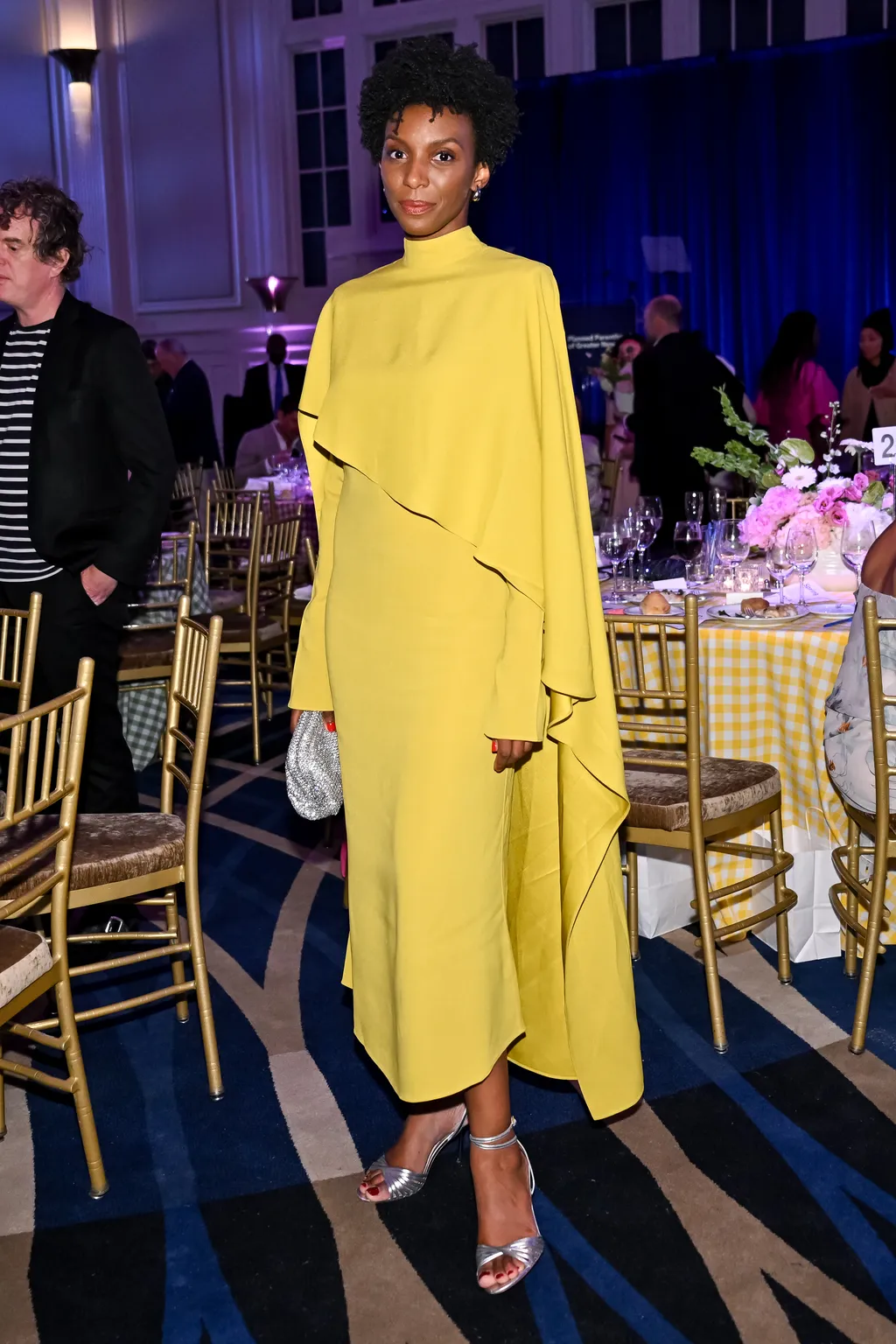 Image may contain Adult Person Clothing Coat and Standing