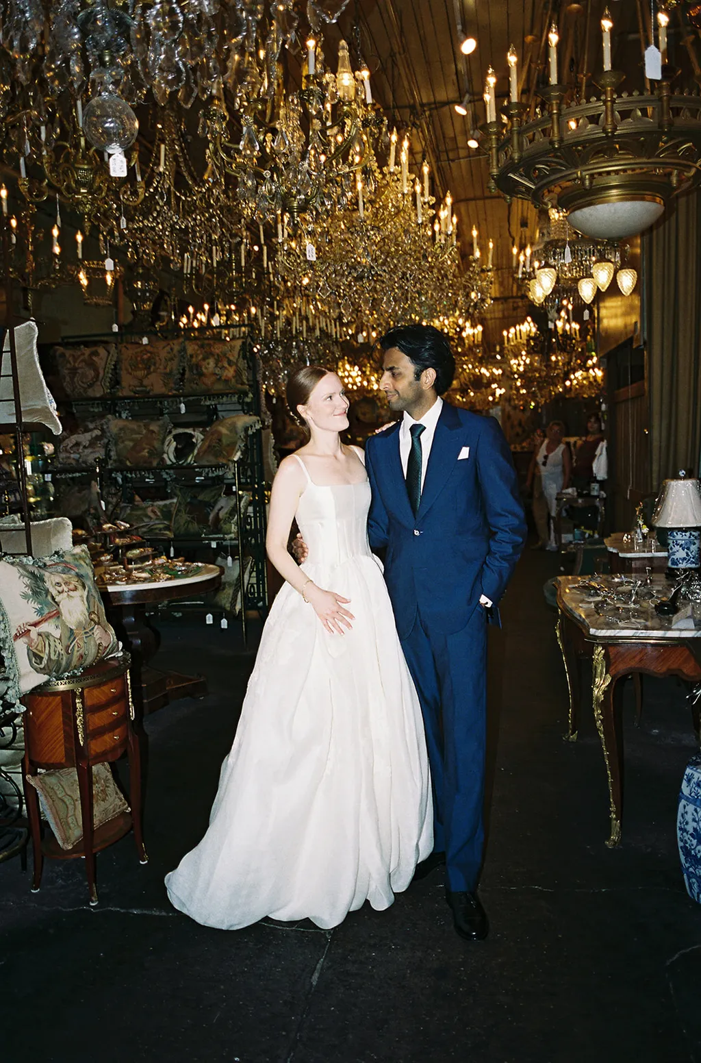 Image may contain Chandelier Lamp Adult Person Wedding Lighting Clothing Dress Fashion Formal Wear and Gown