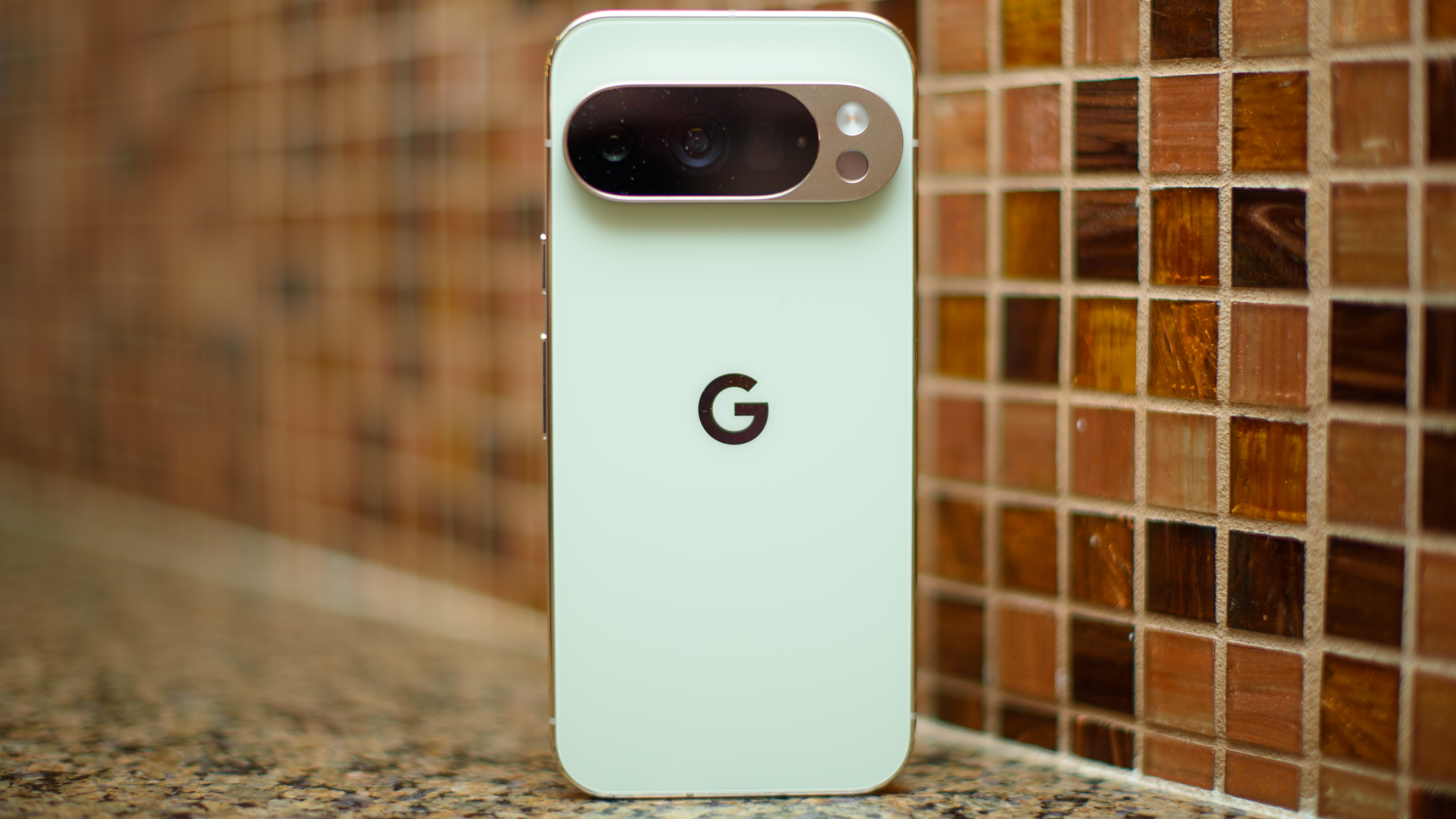 Google Pixel 10 Pro in Jade with checkered tile backsplash background