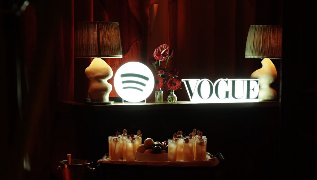 the spotify and vogue logos sitting on a table