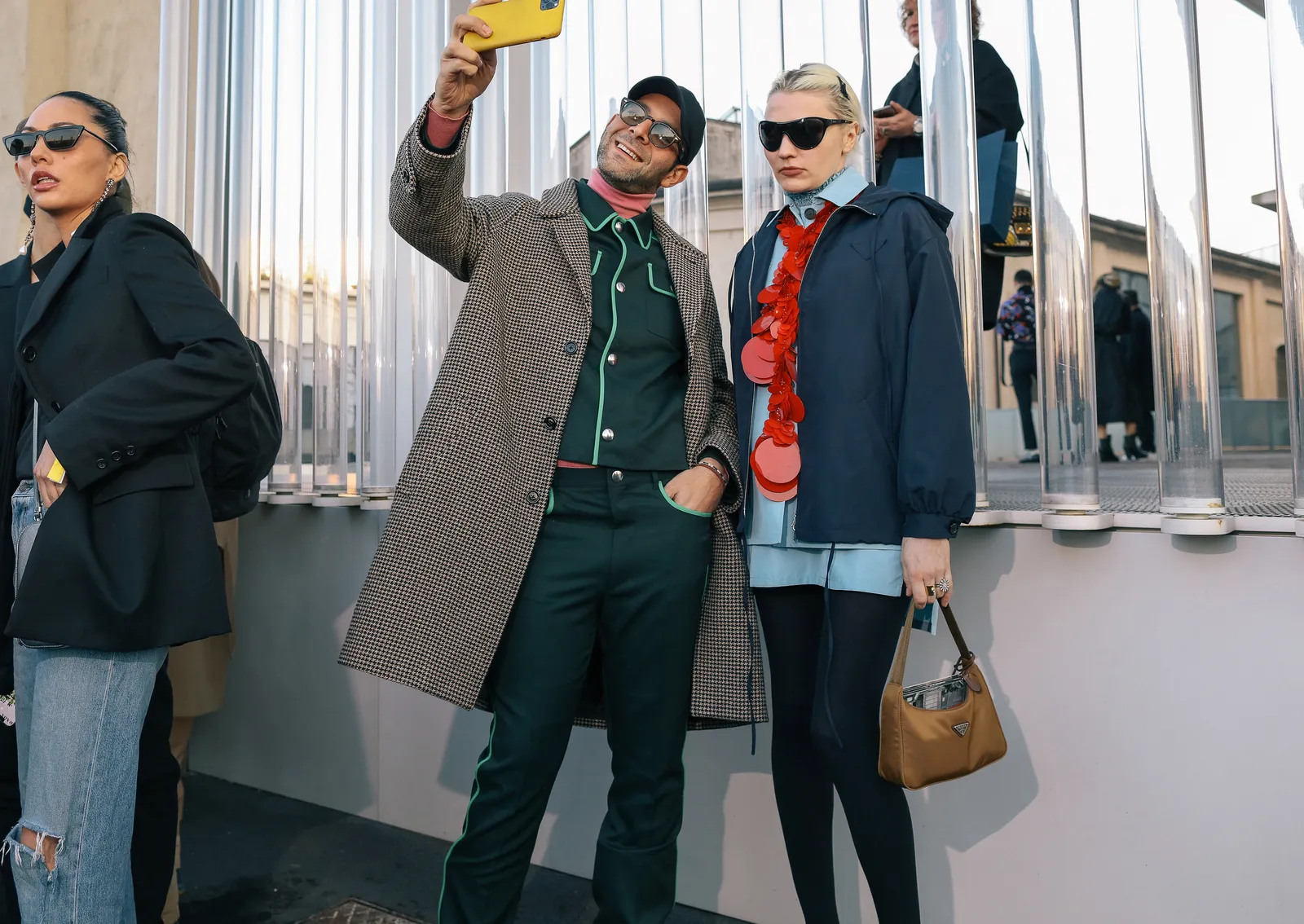 Image may contain Clothing Apparel Human Person Sleeve Sunglasses Accessories Accessory Coat Pants and Overcoat