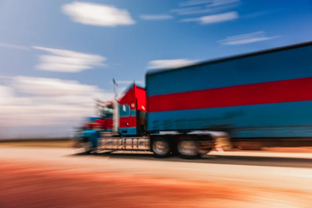 Blurred motion shot showing a semi-truck crossing the Australian outback, Western Australia, Australia