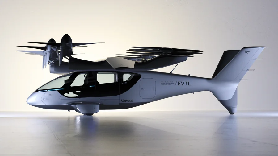 White and black electric aircraft with multiple rotors sits in profile against a plain studio background.