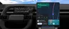 An Android Auto screen displaying a messaging interaction. On the left, a voice command transcription asks to text Leo about being stuck in traffic. On the right, a notification card shows an incoming message from Leo asking "What's your status?" alongside a map navigation view.