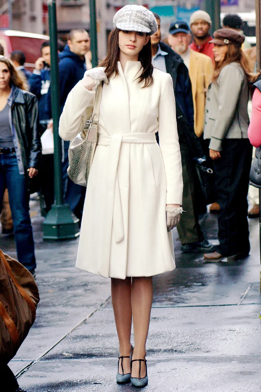 Image may contain Anne Hathaway Tim DuBois Serani Clothing Coat Person Accessories Bag Handbag Adult and Jeans