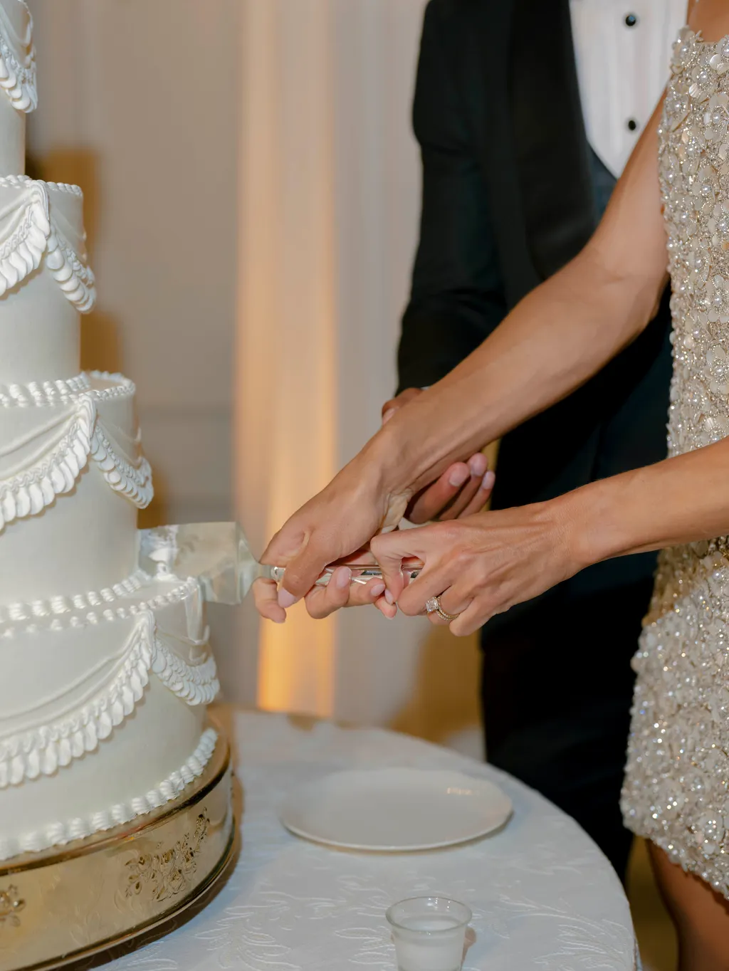 Image may contain Body Part Hand Person Clothing Dress Cake Dessert Food Adult Wedding and Wedding Cake