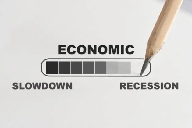 Economic slowdown to be recession loading written on white paper with pencil