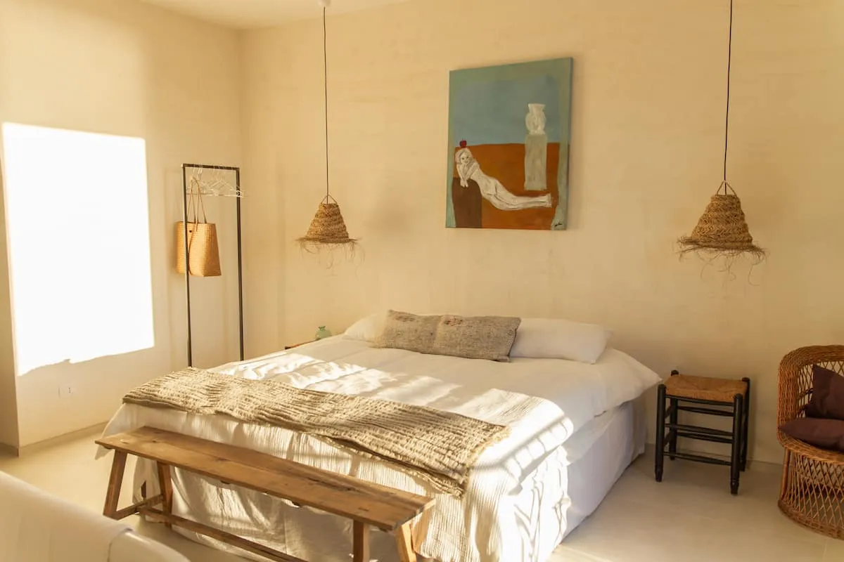 Image may contain Corner Home Decor Indoors Interior Design Lamp Chair Furniture Bed Cushion Bench and Person