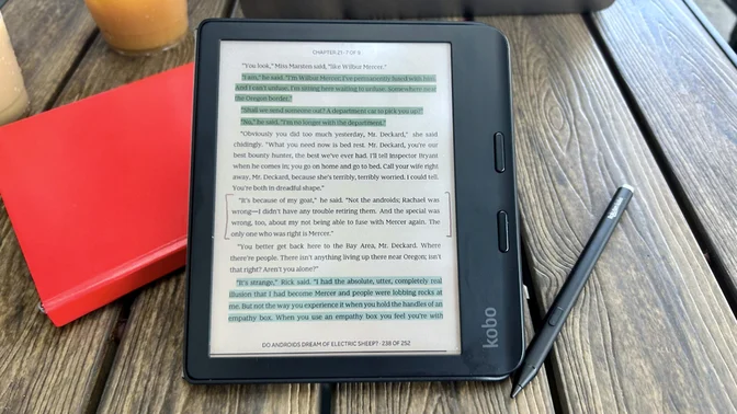 A Kobo Libra Color sitting on a tablet next to a stylus