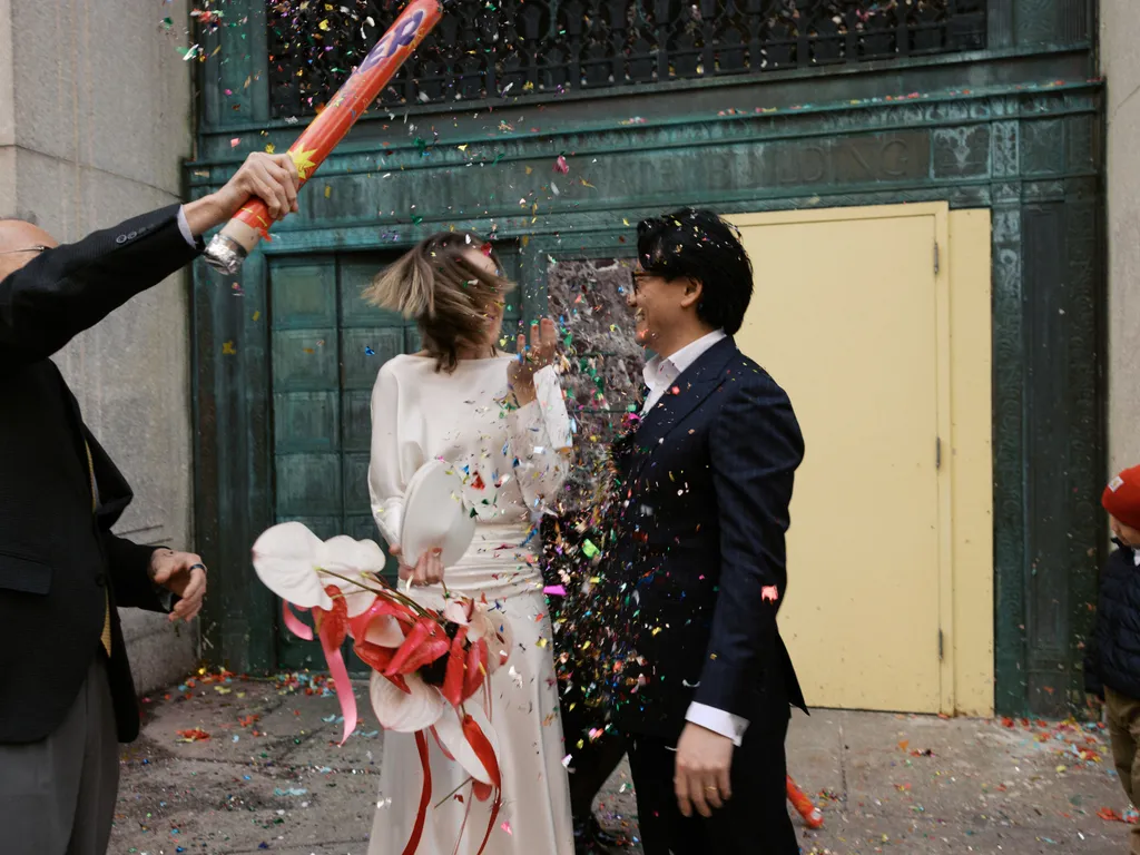 Image may contain Anthony Chan Blazer Clothing Coat Jacket Formal Wear Suit Adult Person Paper and Celebrating