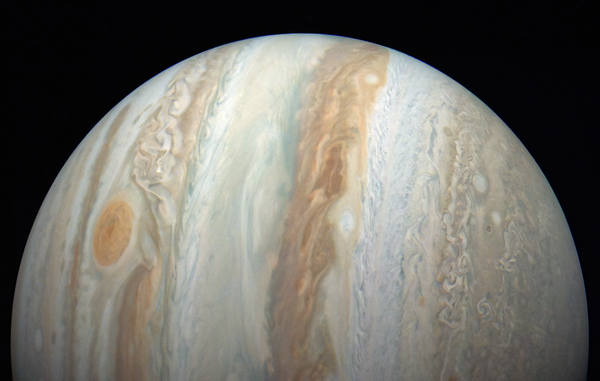 An image of half of Jupiter's disk turned on its side, with its distinctive stripes running vertically and the Great Red Spot to the left.