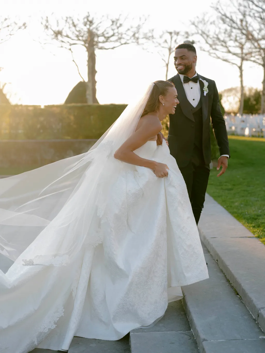 Image may contain Tyreke Evans Emily Sonnett Adult Person Wedding Clothing Dress Fashion Formal Wear and Gown