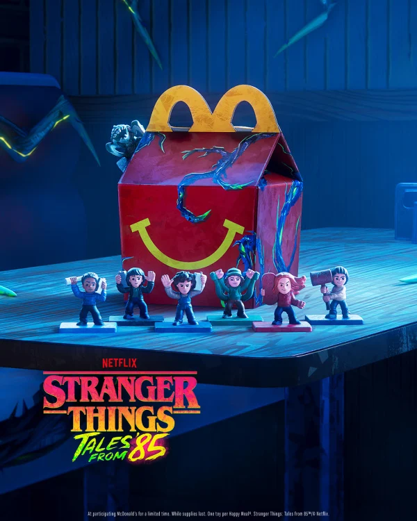 A promotional poster for the "Stranger Things: Tales from '85" Happy Meal.