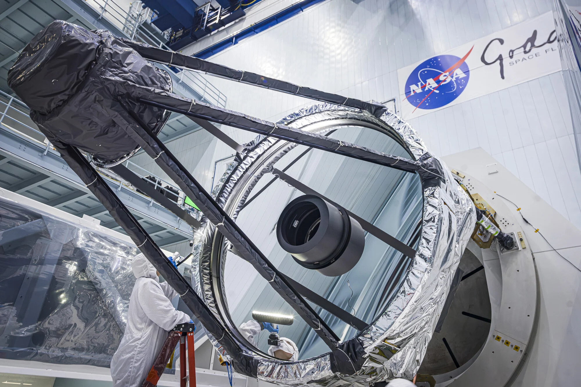Optical Engineer Bente Eegholm inspecting the primary mirror for the Nancy Grace Roman Space Telescope