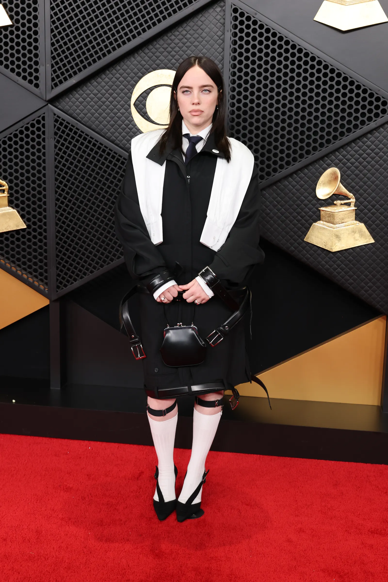Image may contain Billie Eilish Clothing Skirt Fashion Accessories Formal Wear Tie Adult Person Tartan and Coat