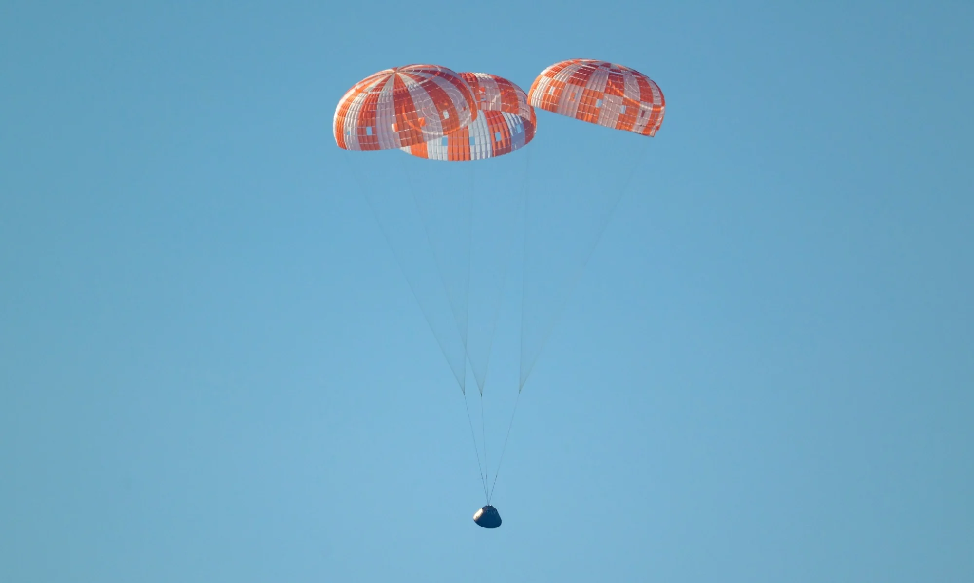 Integrity under parachutes as it lands in the Pacific Ocean off the coast of California