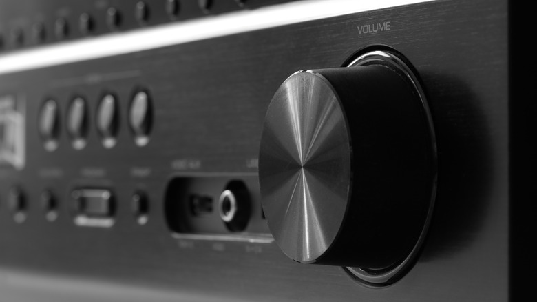 A close-up of an AV receiver on a shelf