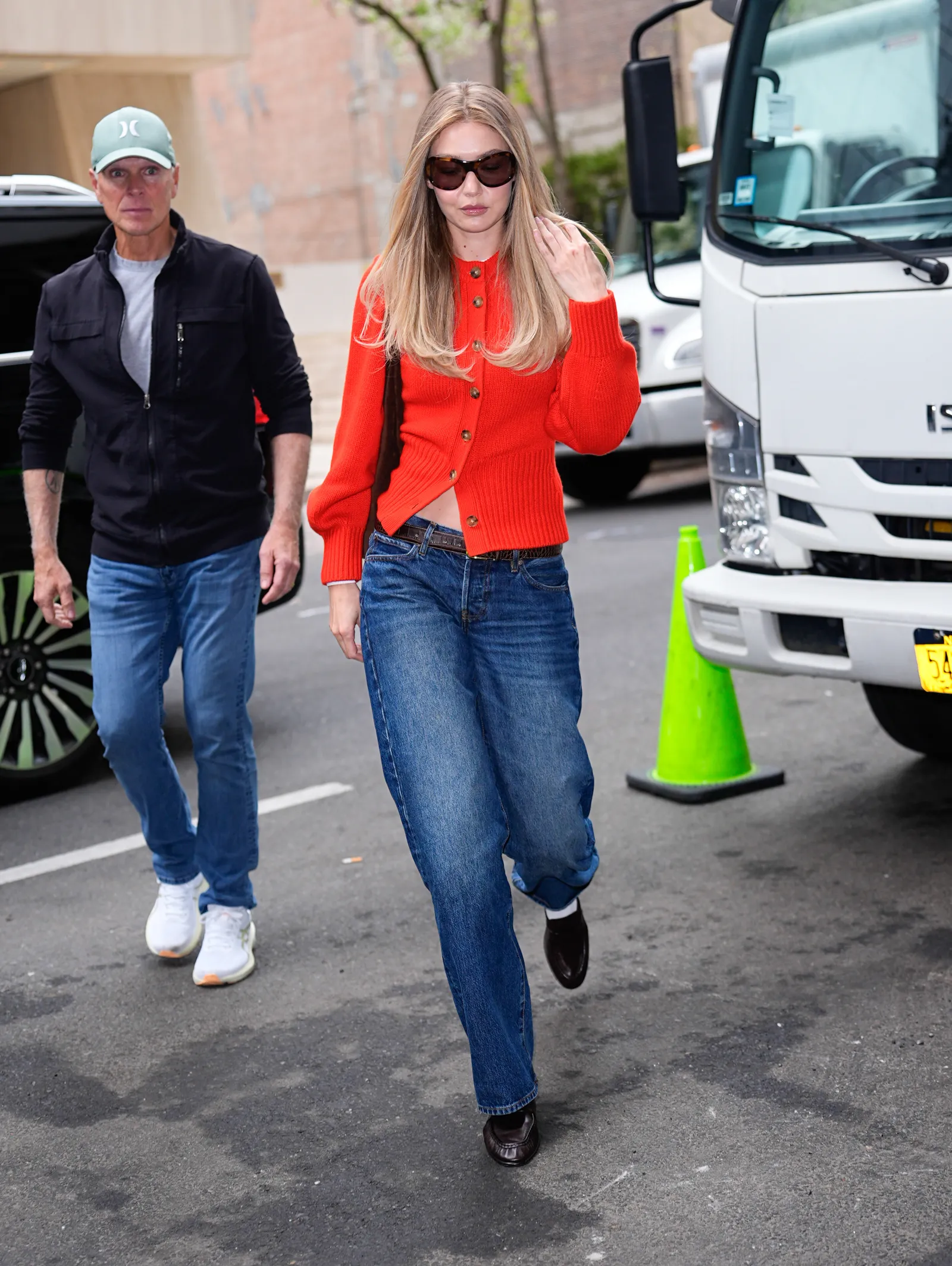 Image may contain Gigi Hadid John Hopfield Clothing Pants Jeans Adult Person Coat Machine and Wheel