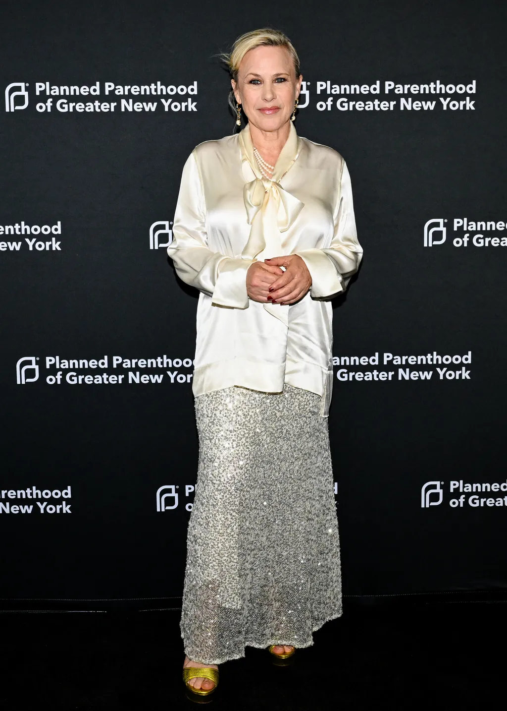 Image may contain Patricia Arquette Blouse Clothing Fashion Adult Person Long Sleeve Sleeve Blonde Hair and Coat