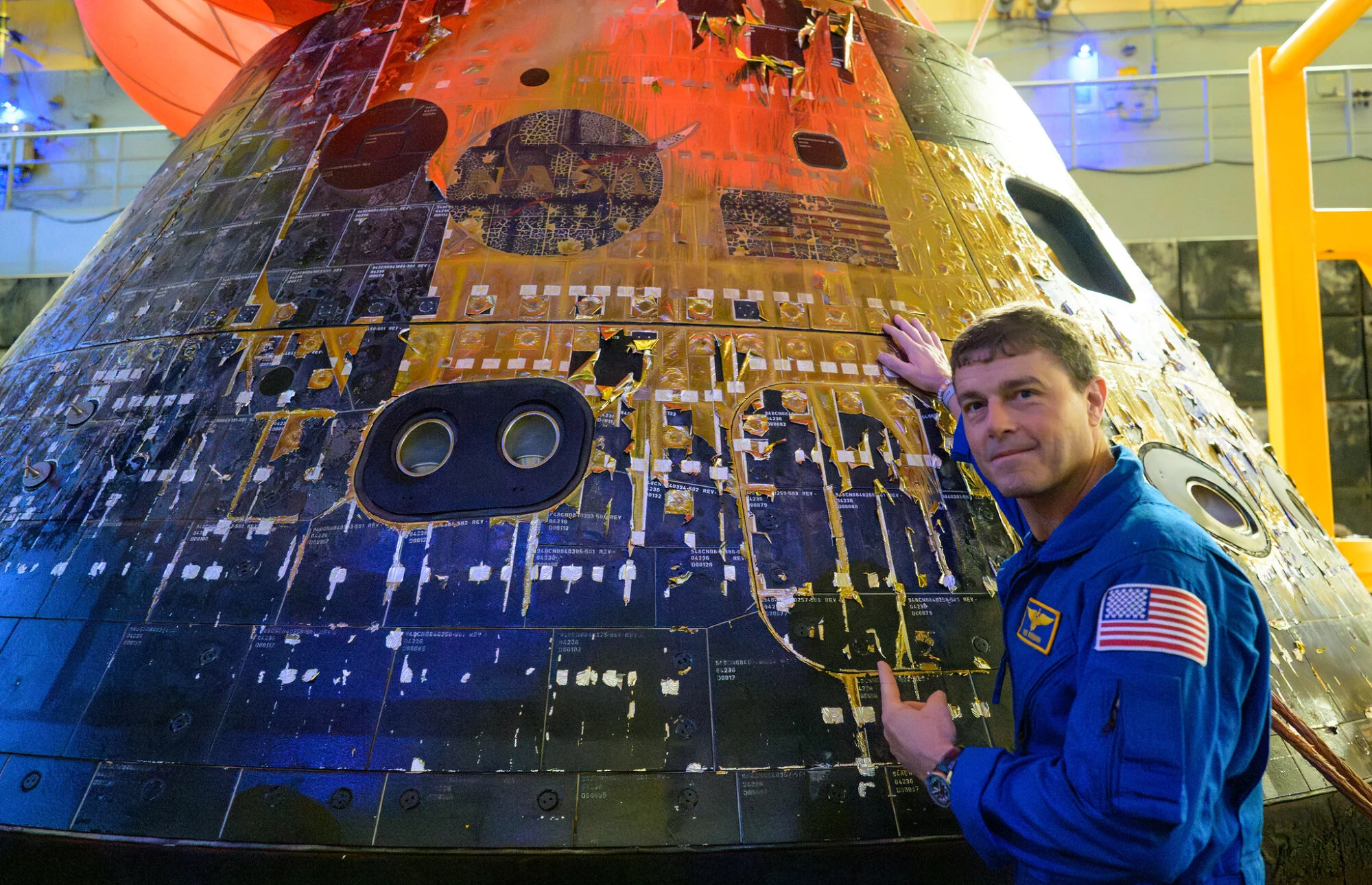 Commander Reid Wiseman, pointing to the stickers on the Orion spacecraft