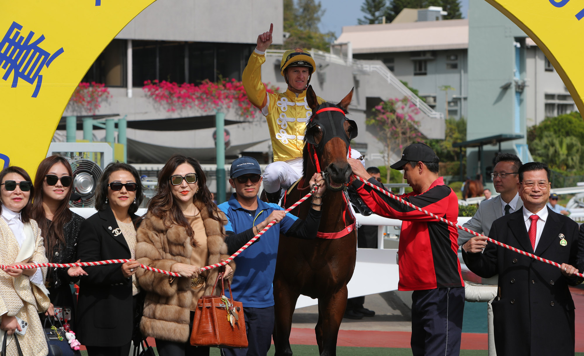 Connections celebrate the win of Crossborderdude at Sha Tin. Connections celebrate the win of Crossborderdude at Sha Tin.