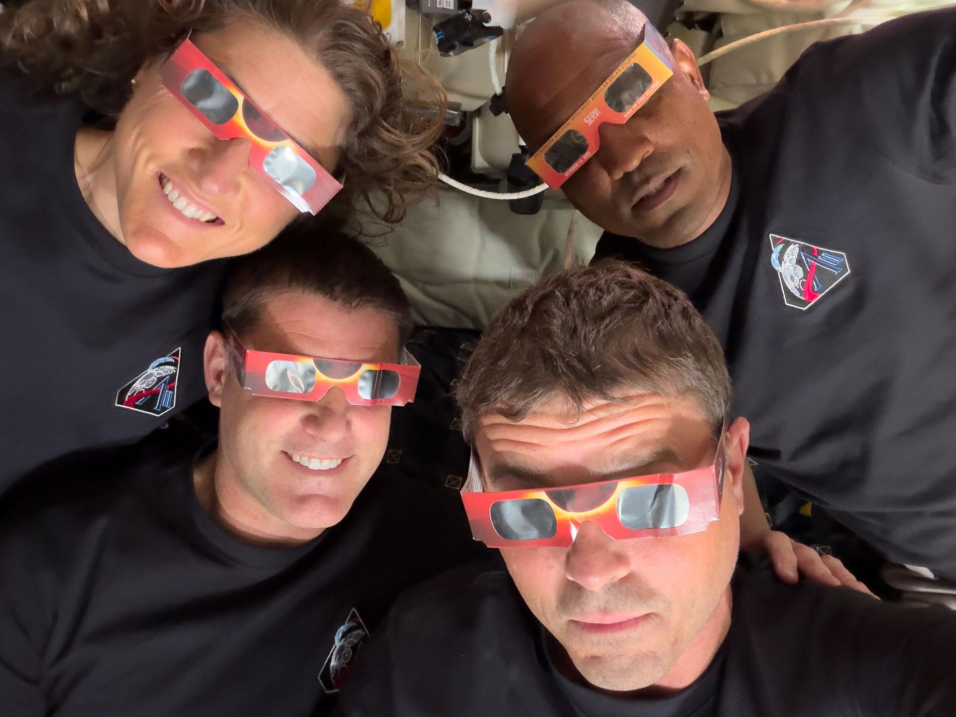The Artemis II astronauts pose in eclipse glasses