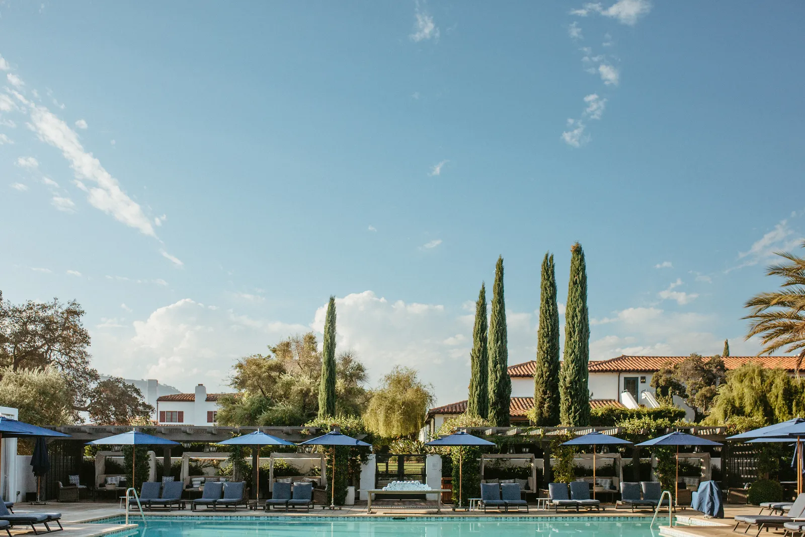 Image may contain Architecture Building Hotel Resort House Housing Villa Chair Furniture Pool Water and Outdoors