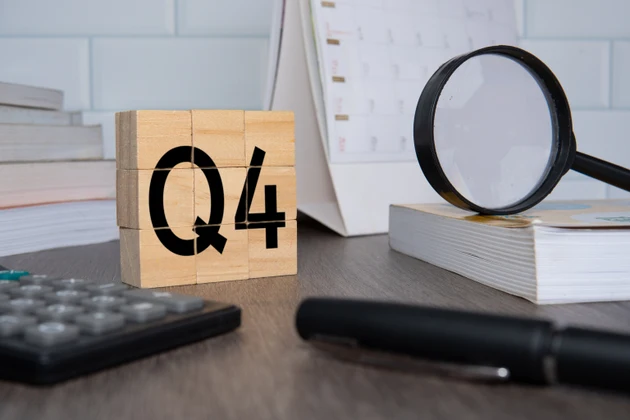 Close up image of wooden cubes with alphabet Q4 on office desk.