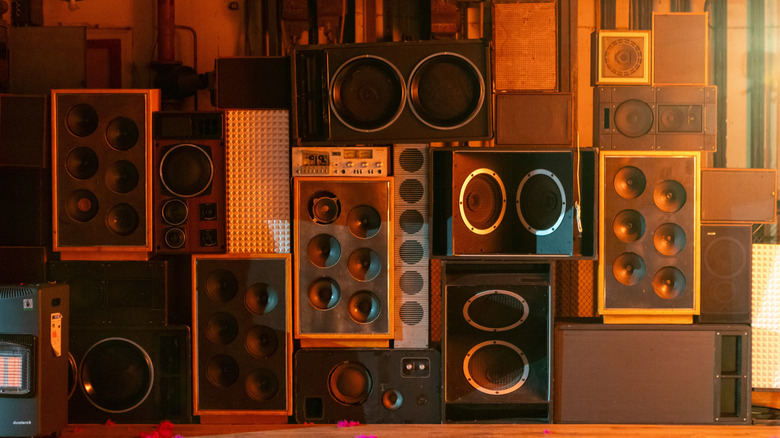 A collection of retro speakers against a garage wall