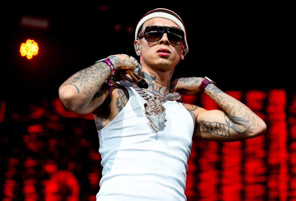 Image may contain Person Skin Tattoo Accessories Sunglasses Performer Solo Performance Adult Face and Head