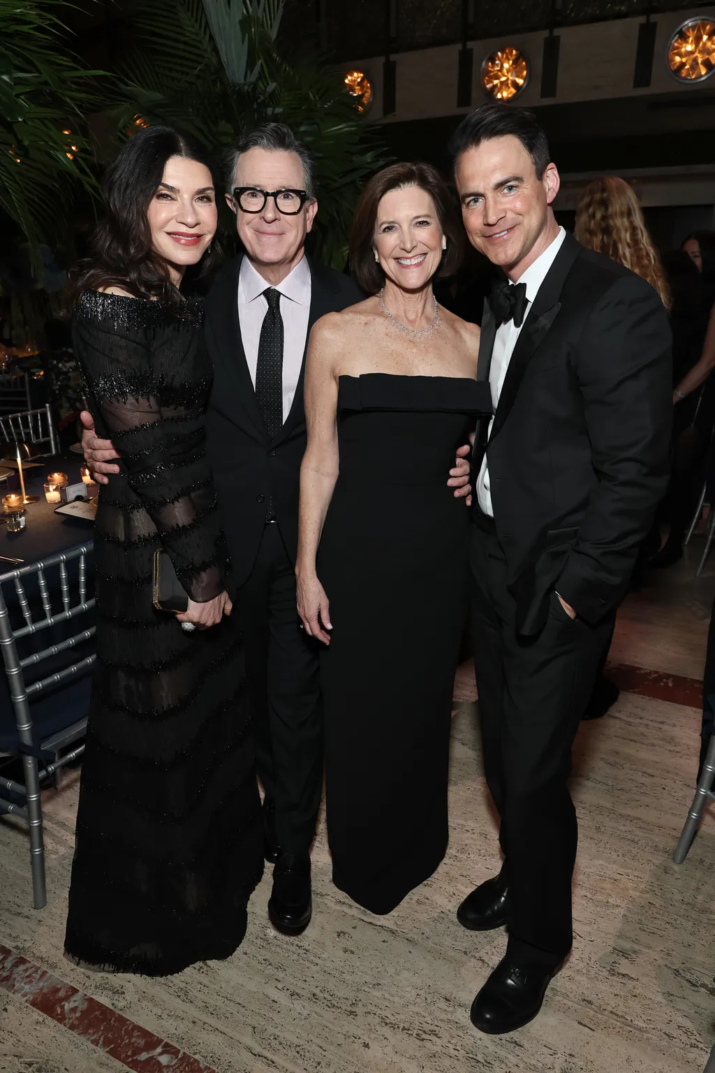 Image may contain Stephen Colbert Julianna Margulies Fashion Adult Person Photobombing Formal Wear Clothing and Suit