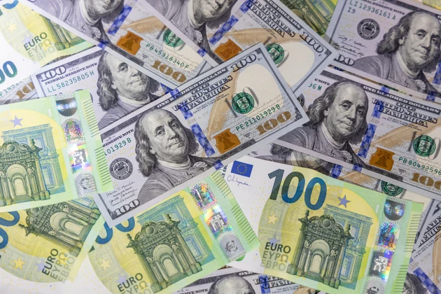 US dollar and euro banknotes arranged together illustrating cost and finance concept