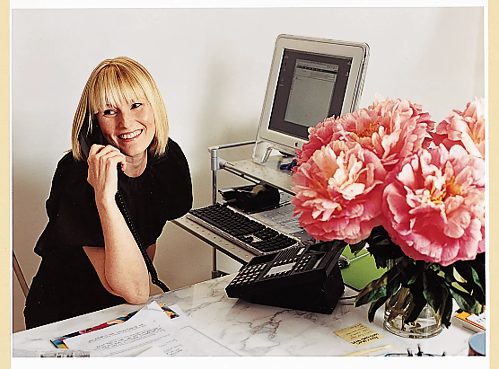 Image may contain Computer Electronics Laptop Pc Furniture Table Adult Person Desk Face Head Flower and Plant