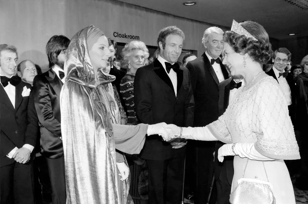 Image may contain Clothing Apparel Suit Coat Overcoat Barbra Streisand Human Person Tuxedo James Caan and Tie