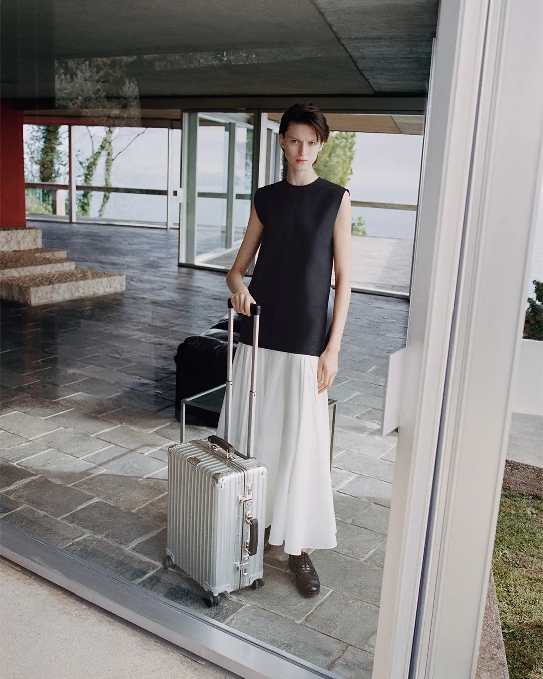 Image may contain Person Teen Baggage Clothing and Skirt