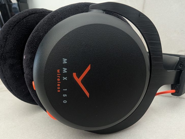 A close-up of Beyerdynamic MMX 150 wireless headphones featuring orange accents.