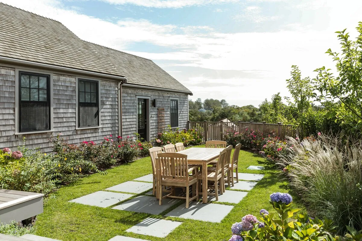 Image may contain Furniture Chair Dining Table Table Patio Plant Grass and Wood