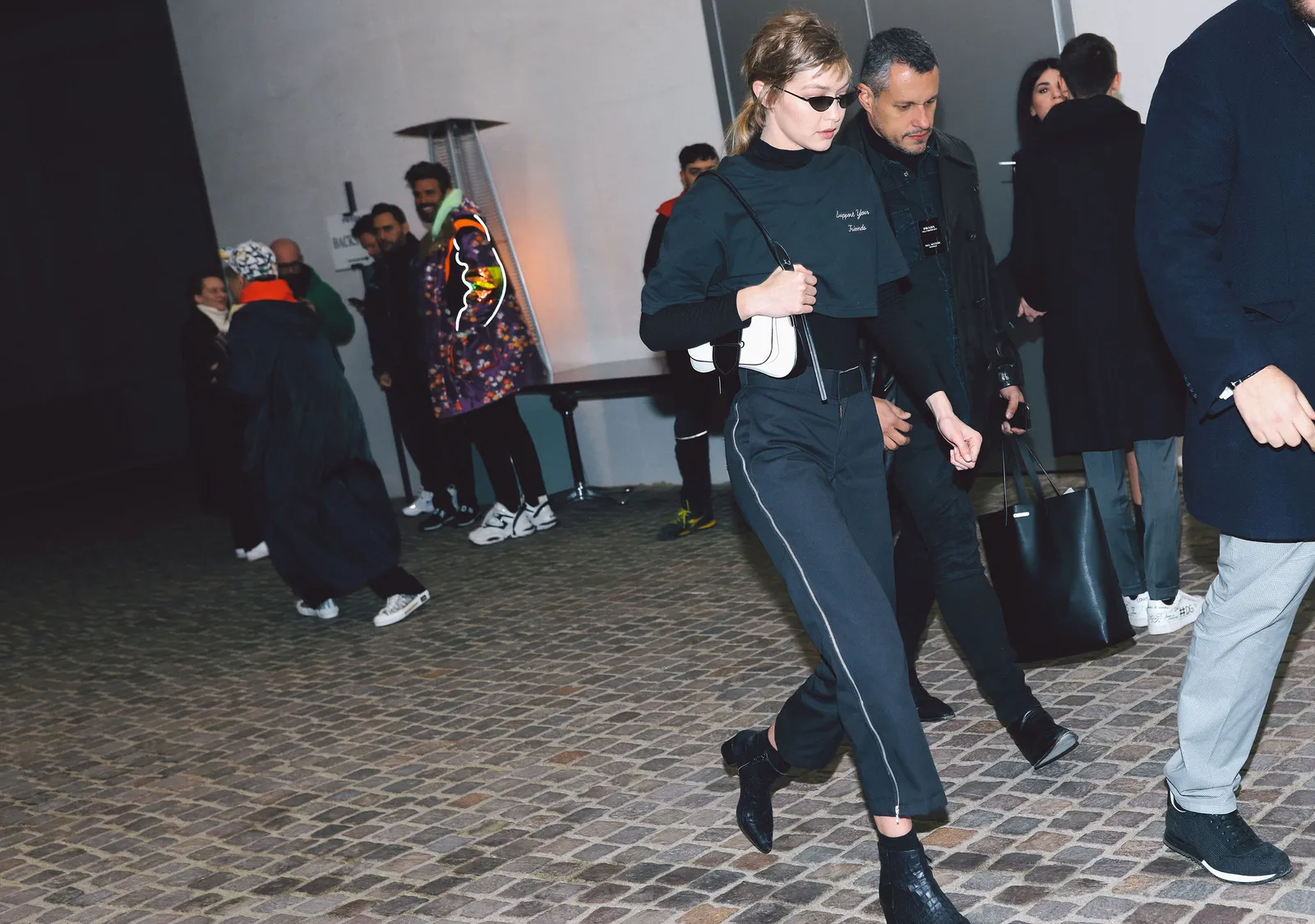 This image may contain Footwear Clothing Shoe Apparel Human Person Suit Coat and Overcoat