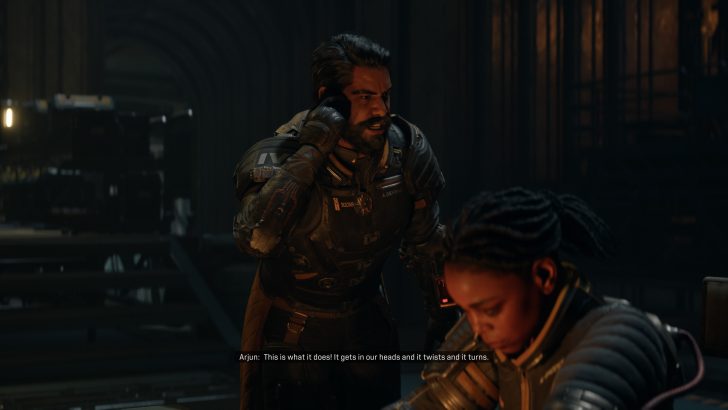 A character in a spacesuit speaking to another seated character in a dimly lit setting with dialogue text reading, Arjun: This is what it does! It gets in our heads and it twists and it turns.