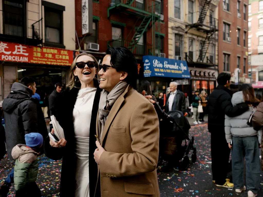 Image may contain Clothing Coat Jacket Blazer City Road Street Urban Head Person Face Accessories and Bag