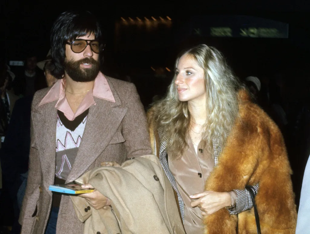Image may contain Barbra Streisand Clothing Apparel Jon Peters Human Person Coat Jacket Overcoat and Suit