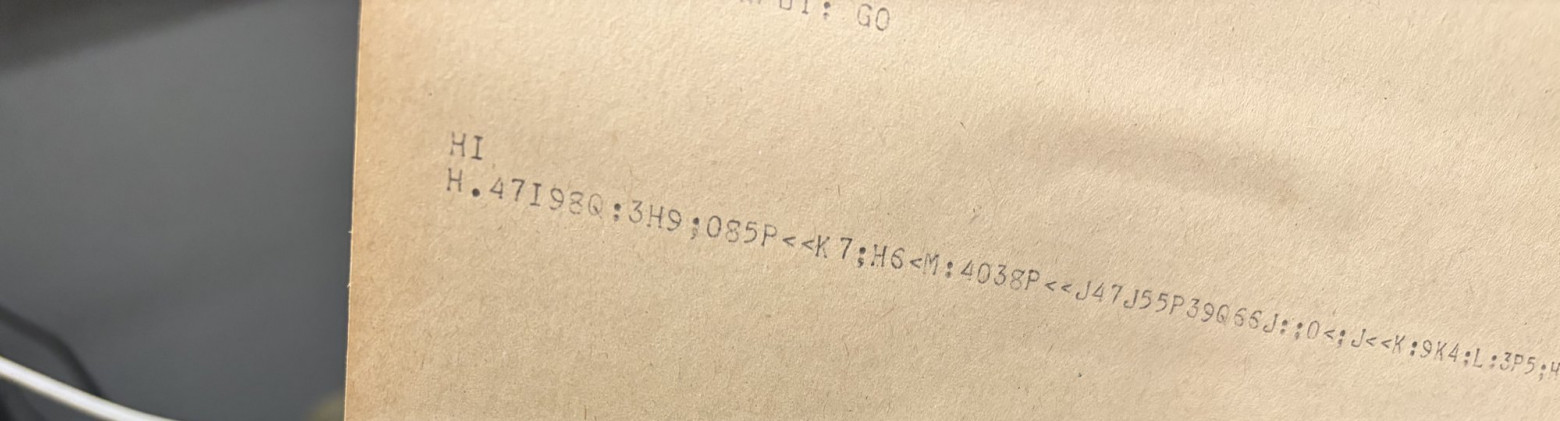 Это явно непохоже на пи Teletype paper showing a line of random ASCII characters instead of the digits of pi.