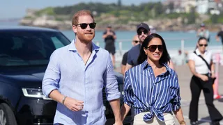 Britain's Prince Harry Duke of Sussex and his wife Meghan Markle the Duchess of Sussex arrive to meet with volunteer...